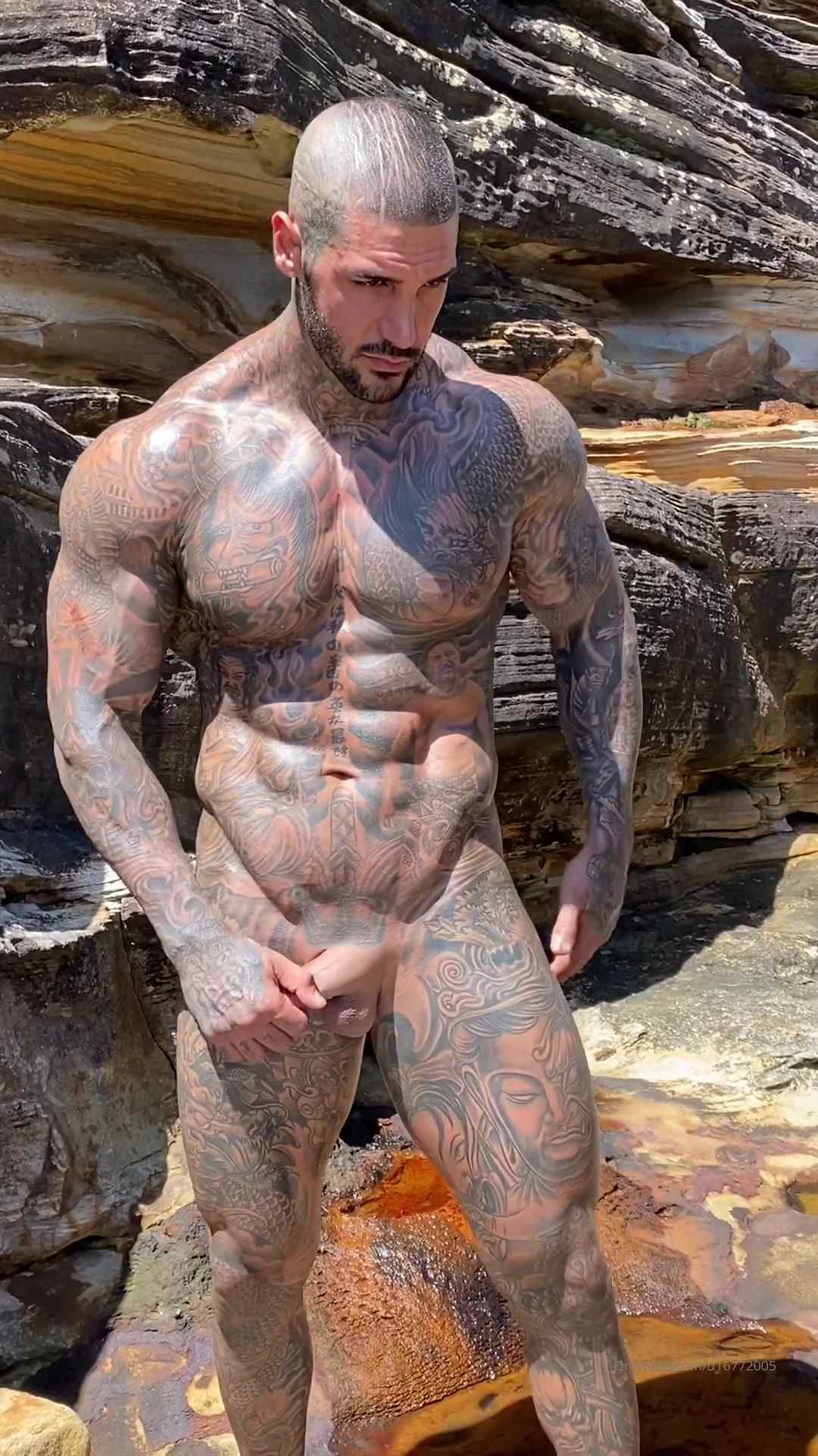 Hot Muslim guy covered in tattoos showing off his body and cock at the beach